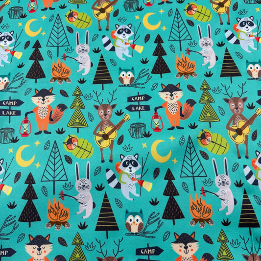Nature's Fabrics woodland animal print fabric with raccoons, foxes, and campfire designs