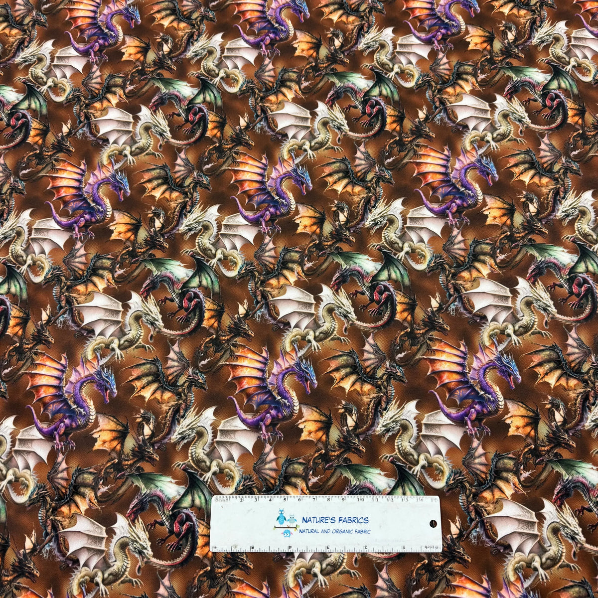 Dragon-patterned fabric by Nature's Fabrics, featuring colorful mythical creatures on natural organic material