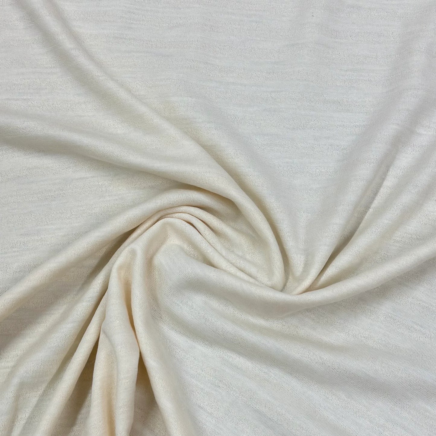 Cream organic cotton knit fabric by Nature's Fabrics, soft texture and natural drape for eco-friendly sewing projects