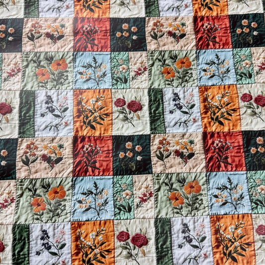 Nature's Fabrics floral embroidered patchwork quilt with botanical patterns