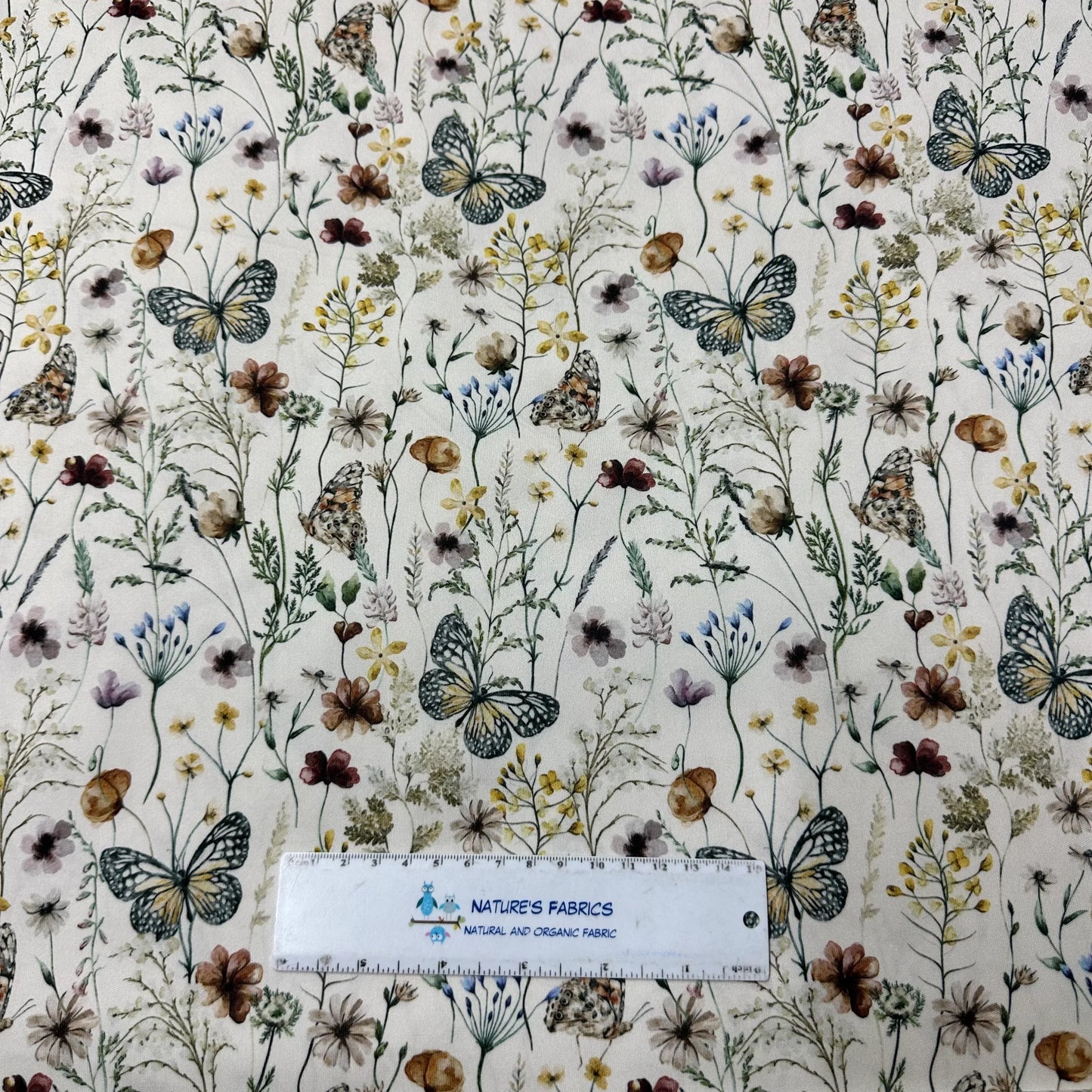 Nature's Fabrics butterfly and wildflower print organic cotton fabric with ruler for scale
