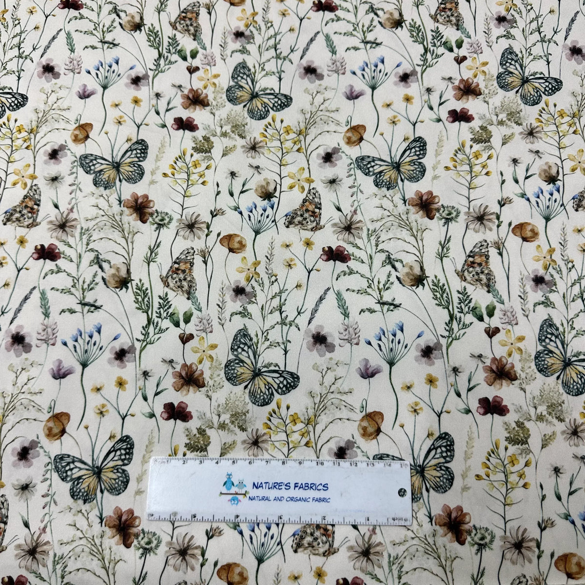Nature's Fabrics butterfly and wildflower print organic cotton fabric with ruler for scale