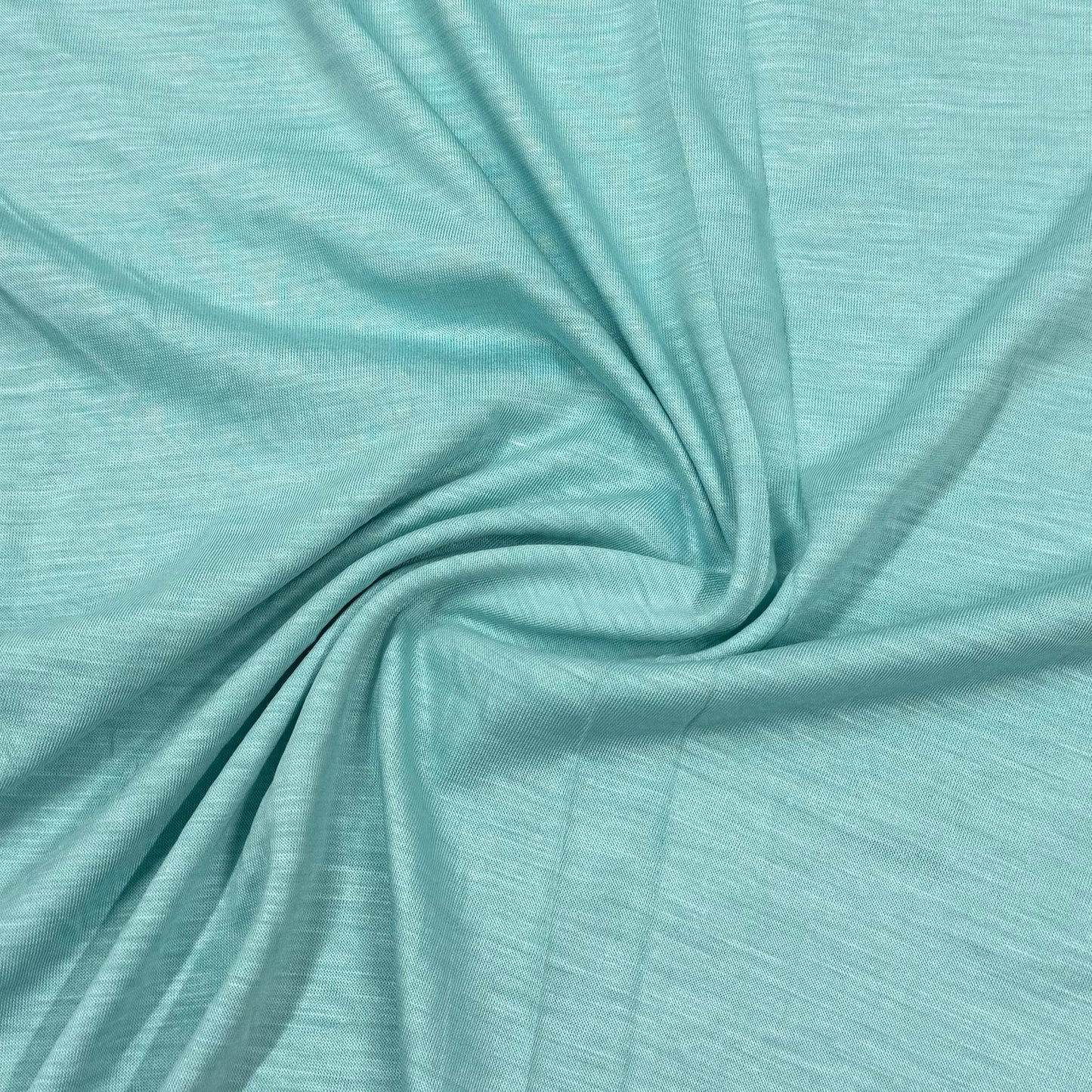 Soft mint green organic cotton fabric by Nature's Fabrics, ideal for eco-friendly sewing projects