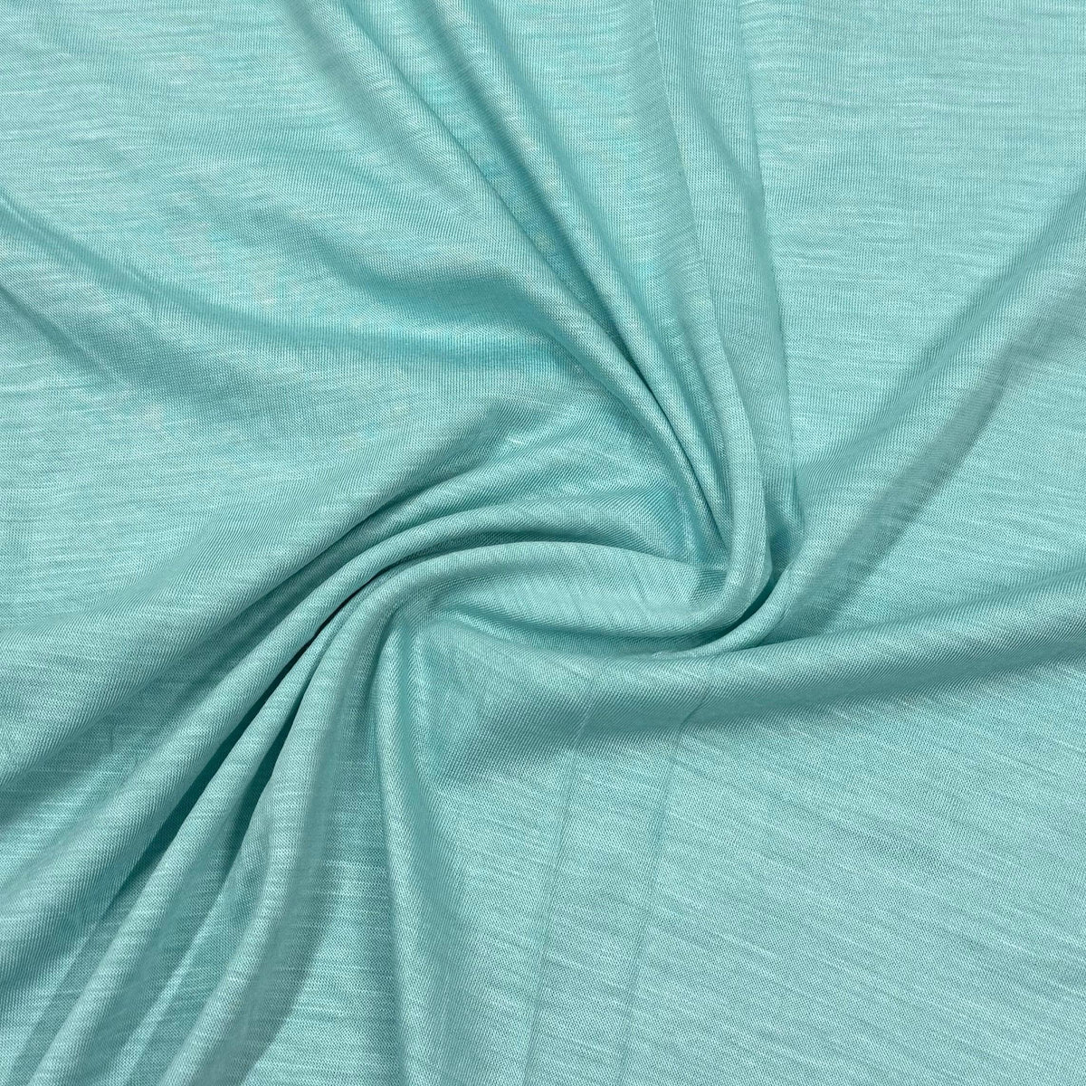 Soft mint green organic cotton fabric by Nature's Fabrics, ideal for eco-friendly sewing projects