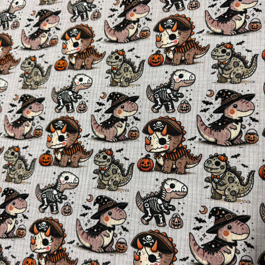 Nature's Fabrics Halloween dinosaur print fabric with skeletons, witches, and pirates.