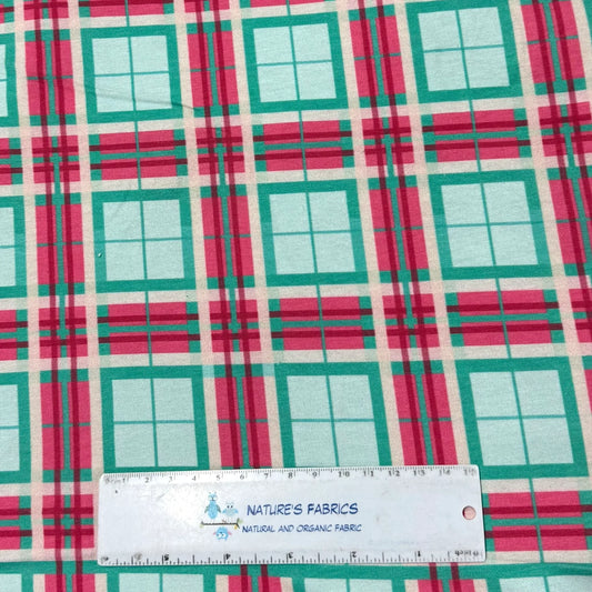 Teal and pink plaid organic fabric from Nature's Fabrics with a measuring ruler.
