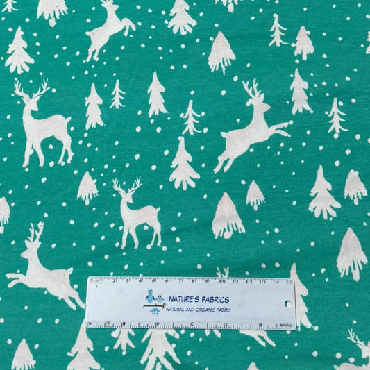 Teal fabric with white reindeer and trees, Nature's Fabrics organic cotton print