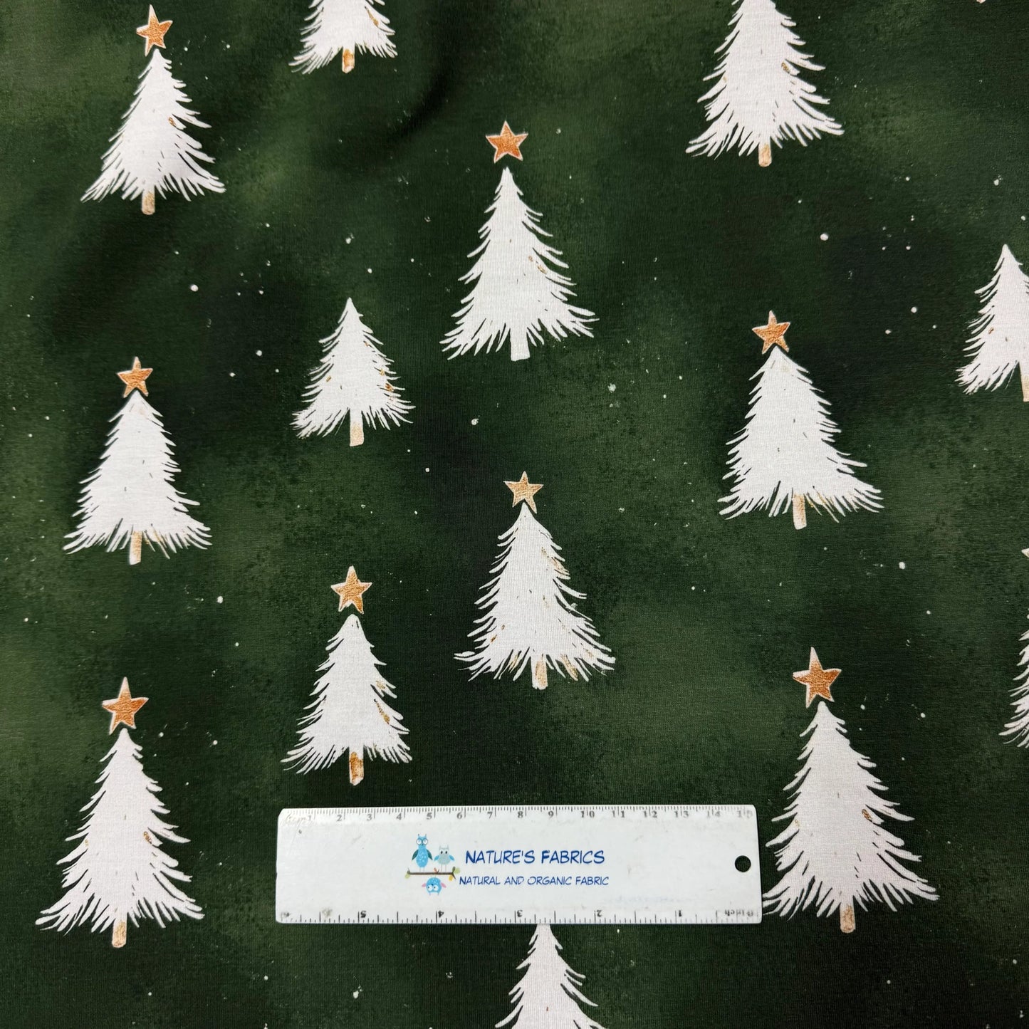 Nature's Fabrics green fabric with white Christmas trees and gold stars, organic cotton