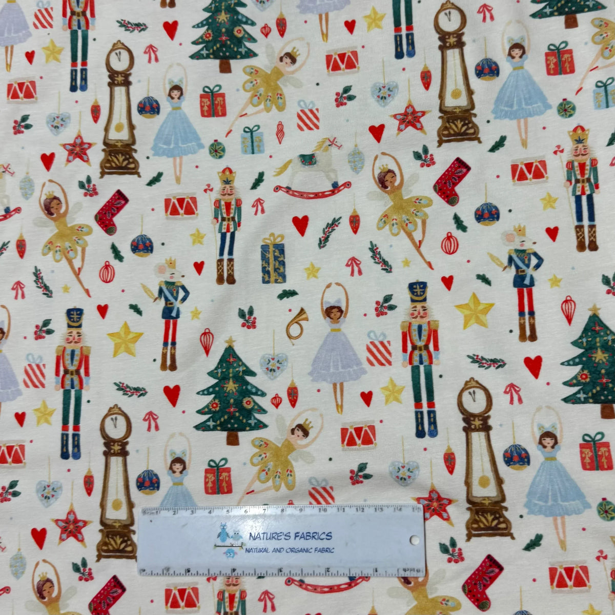 Nature's Fabrics Nutcracker holiday print fabric with ballet dancers, trees, gifts, and ornaments on white background