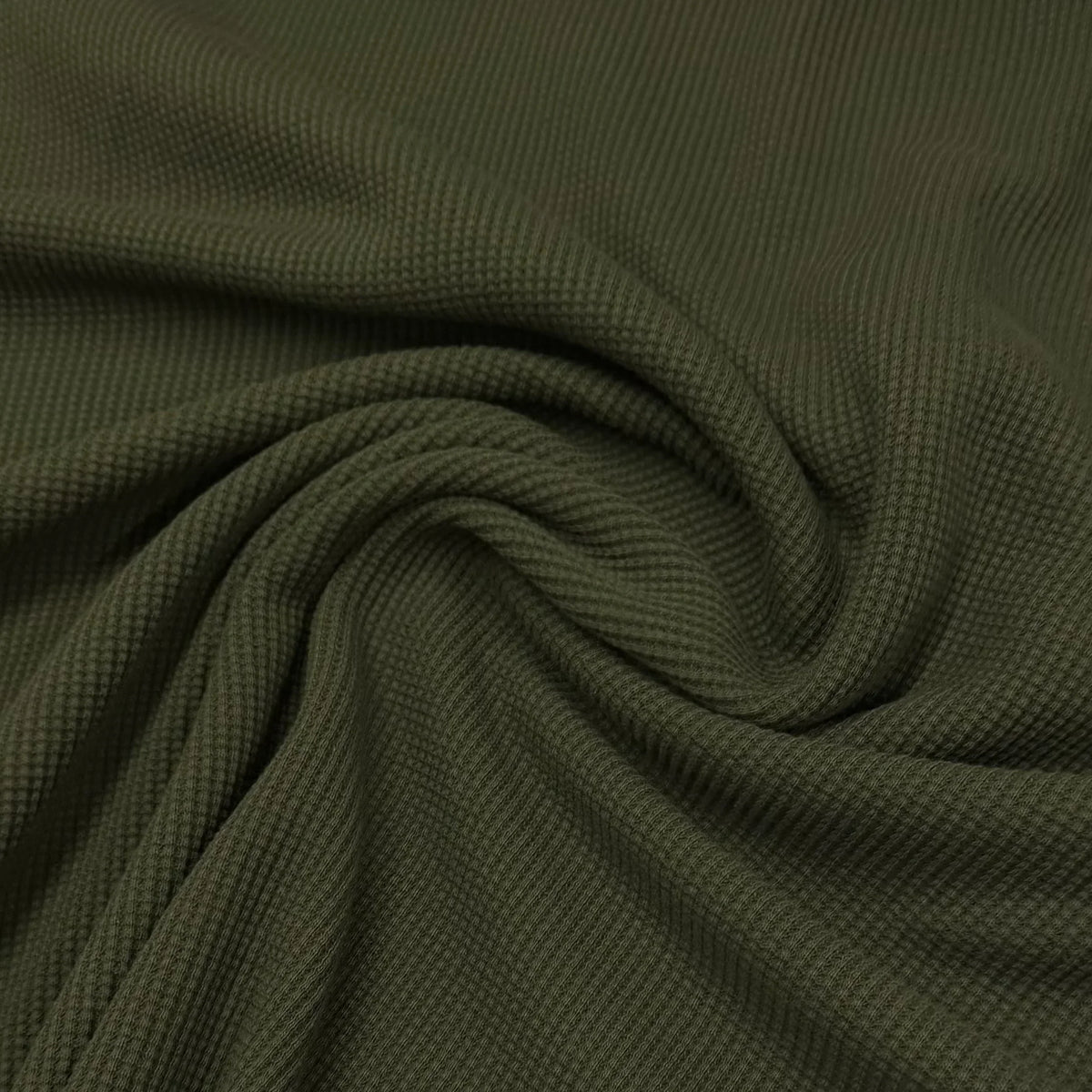 Olive green waffle knit fabric by Nature's Fabrics, soft texture ideal for eco-friendly sewing projects