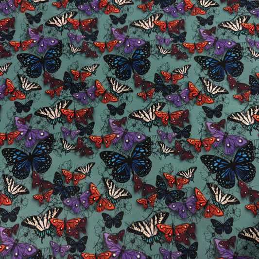 Nature's Fabrics teal textile with colorful blue, orange, and purple butterfly pattern