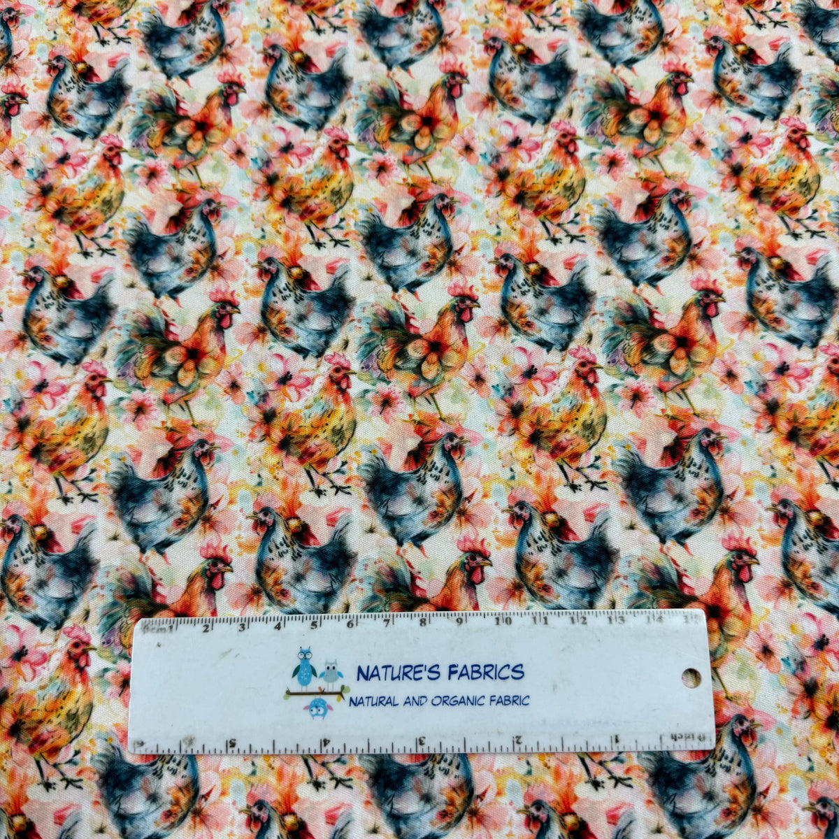 Chicken print fabric by Nature's Fabrics, featuring colorful roosters and hens on natural organic cotton yardage.
