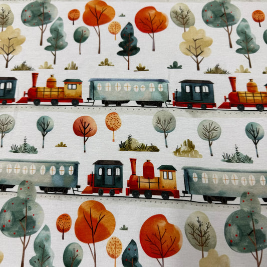 Nature's Fabrics organic cotton textile with watercolor trains and colorful autumn trees.