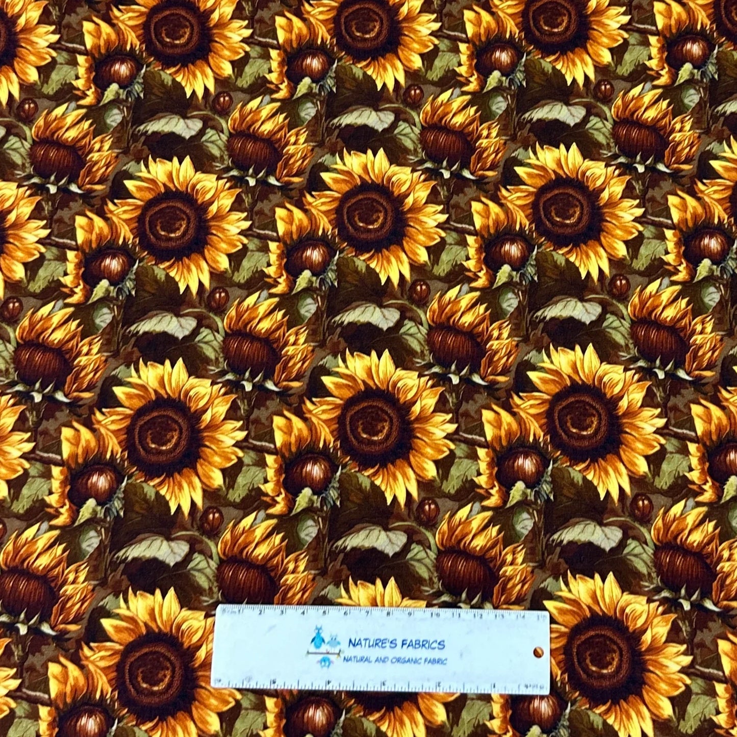 Sunflower print fabric by Nature's Fabrics — vibrant yellow blooms on dark background, organic cotton yardage