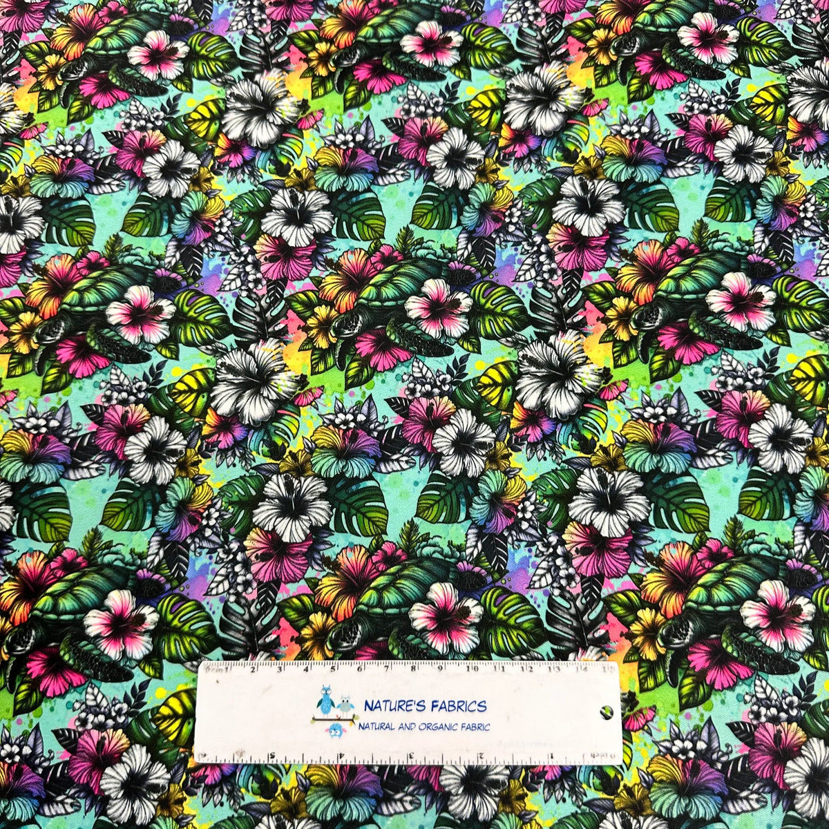 Vibrant tropical hibiscus and monstera leaf print fabric by Nature's Fabrics, natural organic cotton yardage