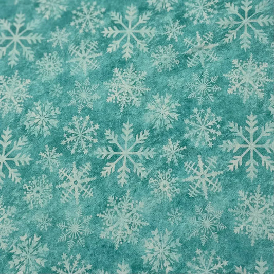 Teal fabric with white snowflake pattern, winter-themed textile design