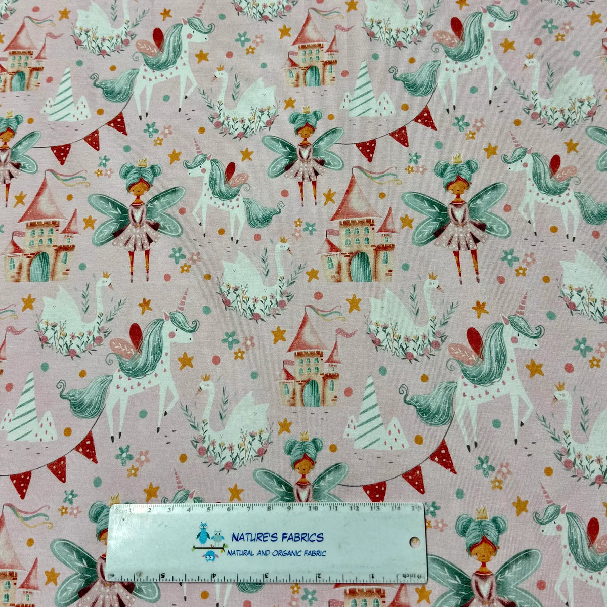 Nature's Fabrics pink fairy unicorn print organic cotton fabric with castles, stars, and swans
