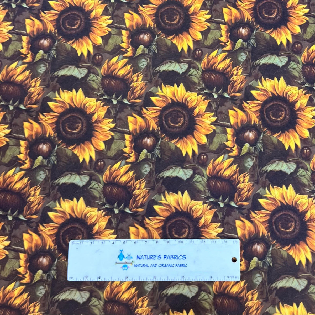 Sunflower print fabric by Nature's Fabrics — vibrant yellow blooms on dark background, natural organic cotton yardage