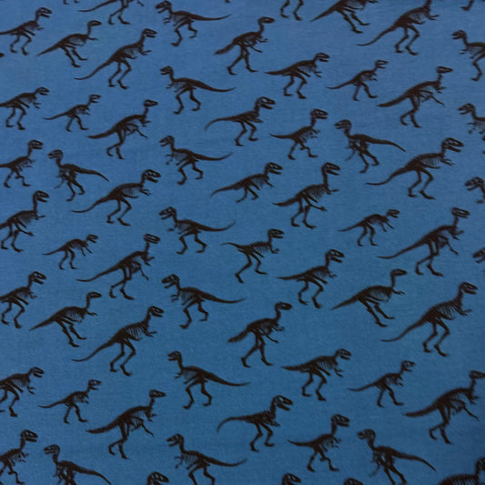 Blue Nature's Fabrics fabric with a repeating black dinosaur skeleton pattern.