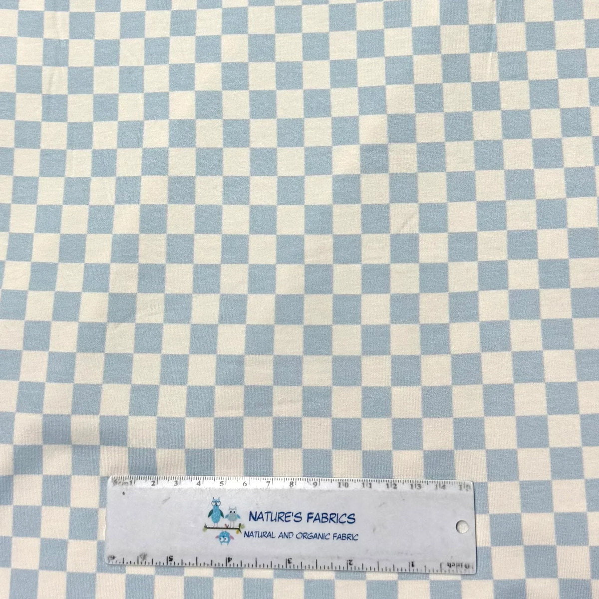 Light blue and white checkered fabric by Nature's Fabrics, natural organic cotton yardage with ruler for scale