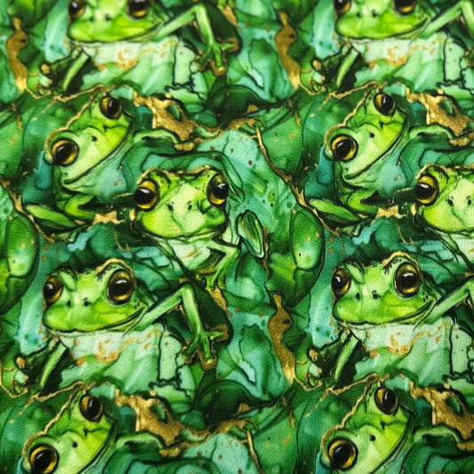 Green frog print fabric by Nature's Fabrics, featuring playful frogs on leafy background, ideal for eco-friendly crafting.