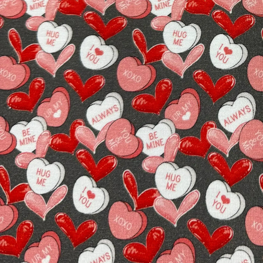 Nature's Fabrics gray cotton fabric with red, pink, and white Valentine's Day heart patterns