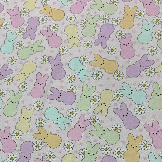 Pastel Easter bunny and daisy print fabric by Nature's Fabrics, ideal for spring crafts and sewing projects.