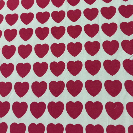 Nature's Fabrics white organic cotton fabric with red heart pattern