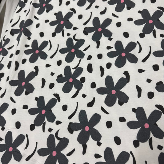 Nature's Fabrics white fabric with dark grey floral print and pink centers