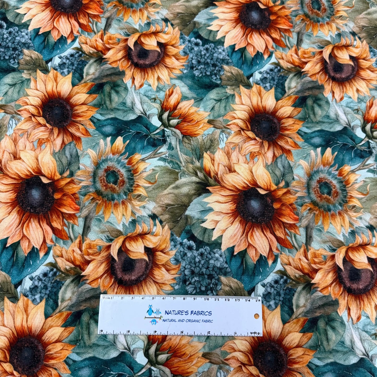 Sunflower print fabric by Nature's Fabrics, organic cotton with vibrant blooms and green leaves