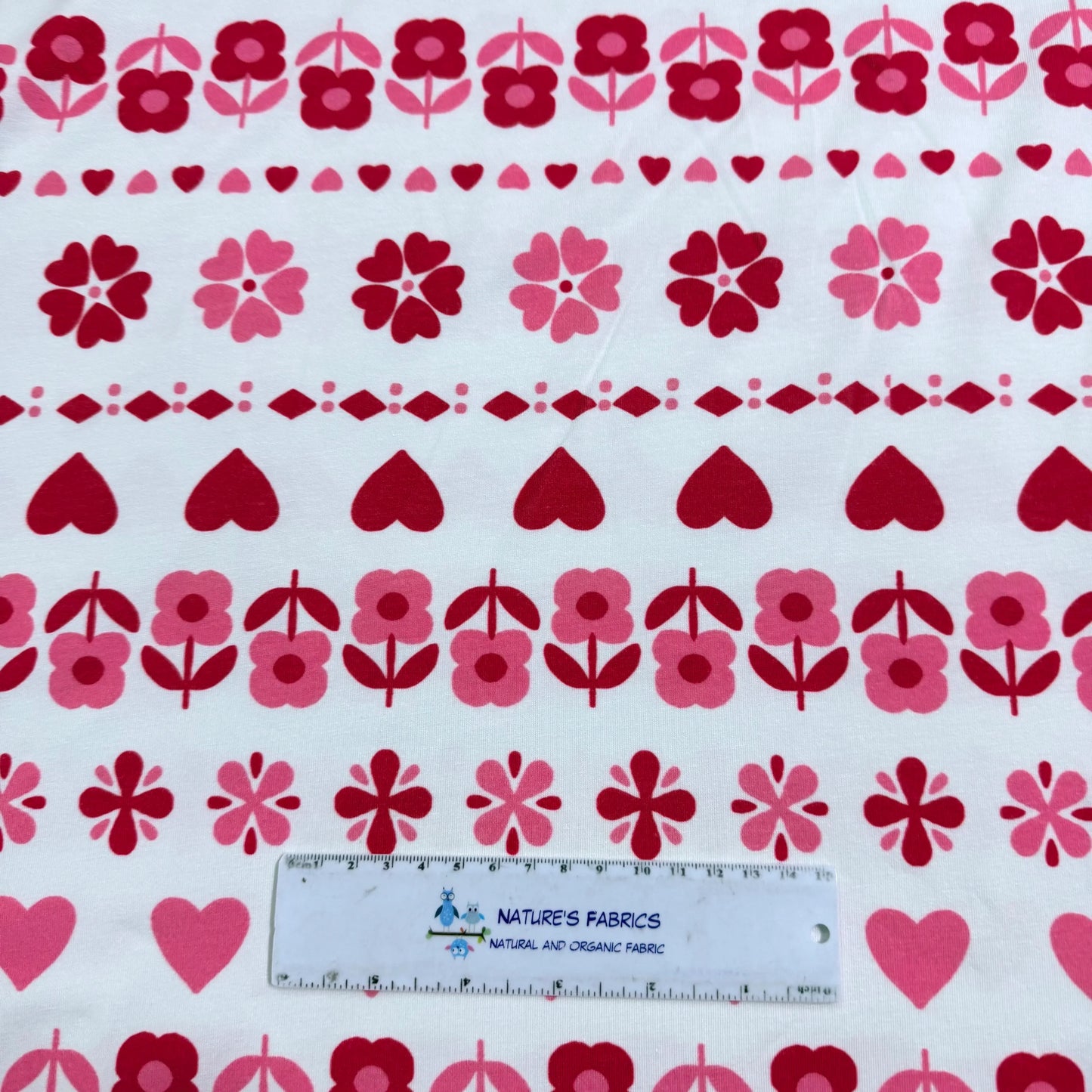 Nature's Fabrics floral and heart patterned organic cotton fabric with ruler for scale