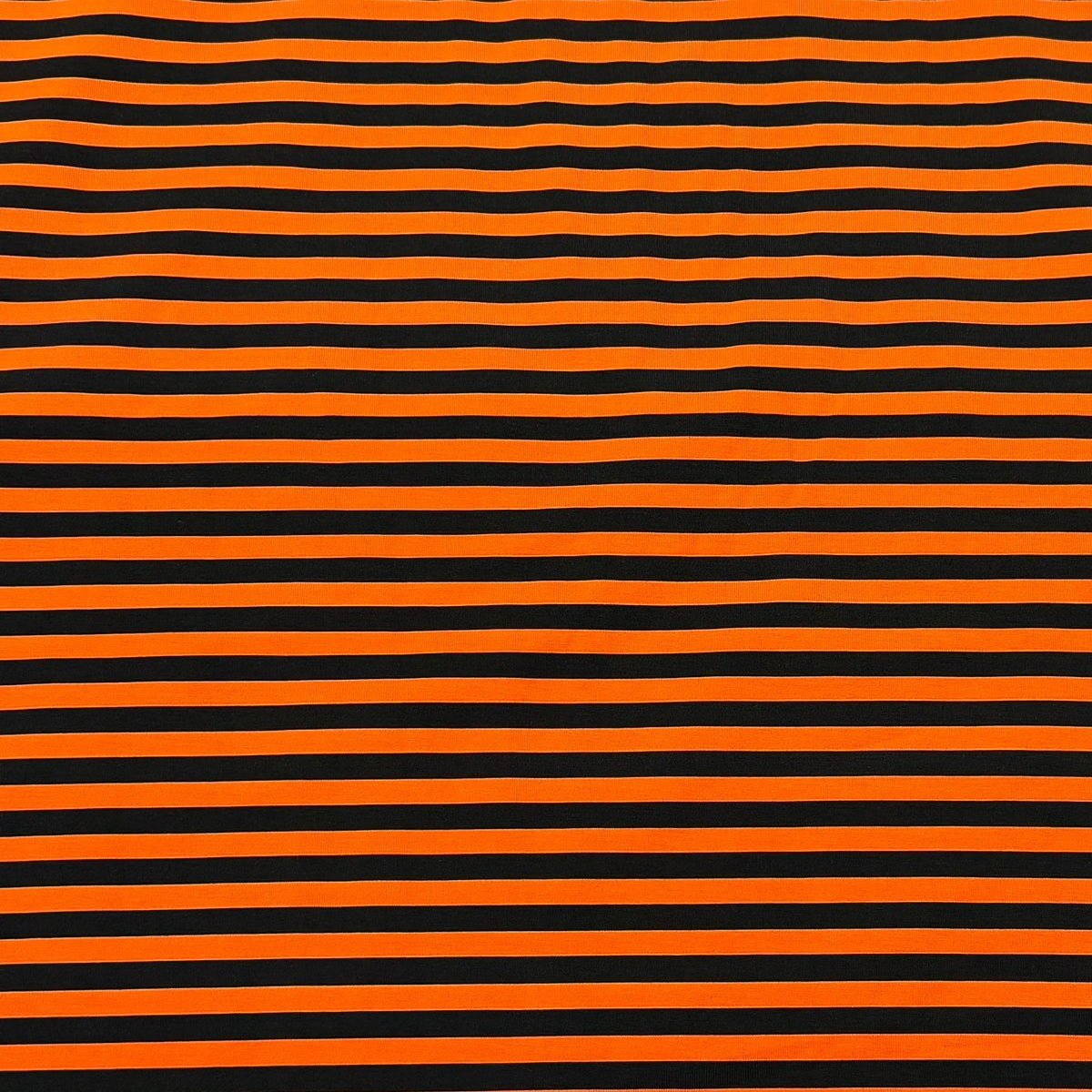 Orange and black horizontal striped fabric from Nature's Fabrics