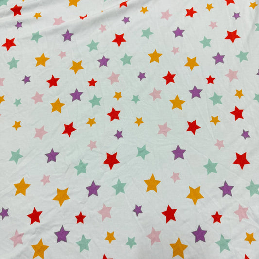Nature's Fabrics white organic cotton fabric with colorful multi-colored star print