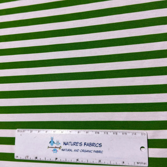 Green and white striped organic cotton fabric by Nature's Fabrics, natural and organic fabric with ruler for scale