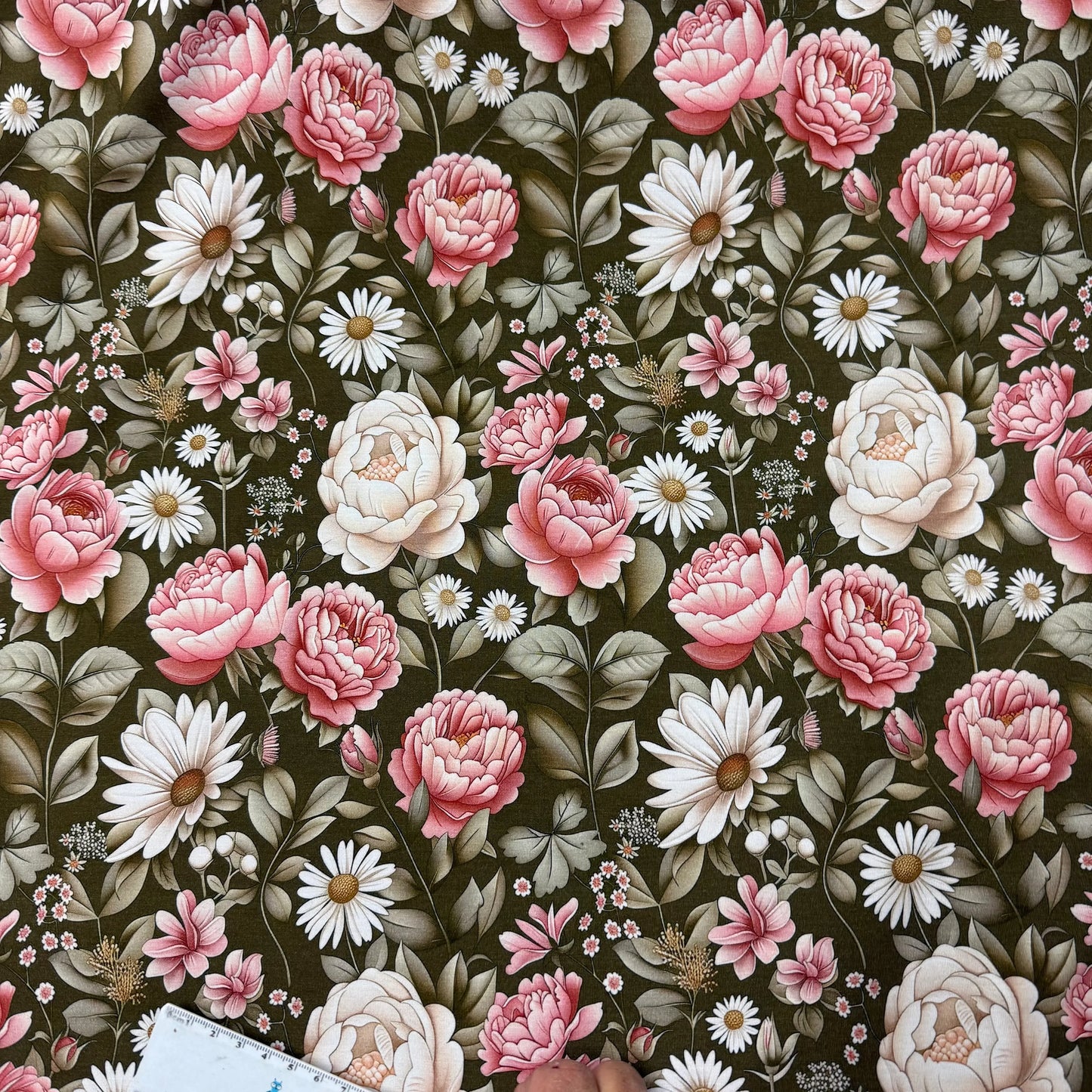 Nature's Fabrics floral print fabric with pink peonies, white daisies, and green leaves on dark background