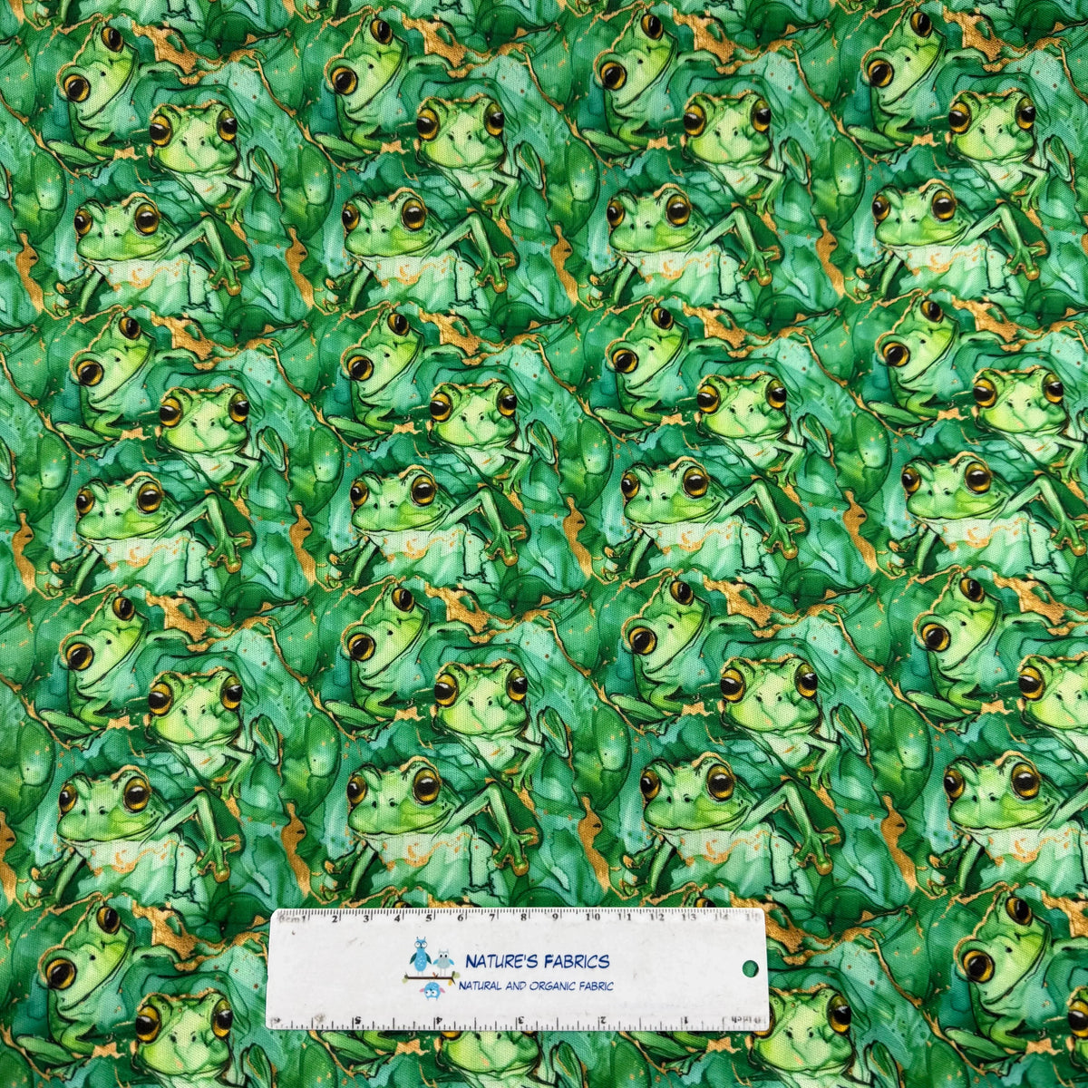 Green frog print fabric by Nature's Fabrics, featuring playful frogs on natural organic cotton, ideal for eco-friendly sewing projects.