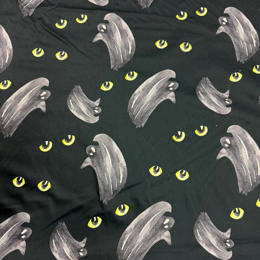 Nature's Fabrics black fabric with grey ghost and yellow eye patterns