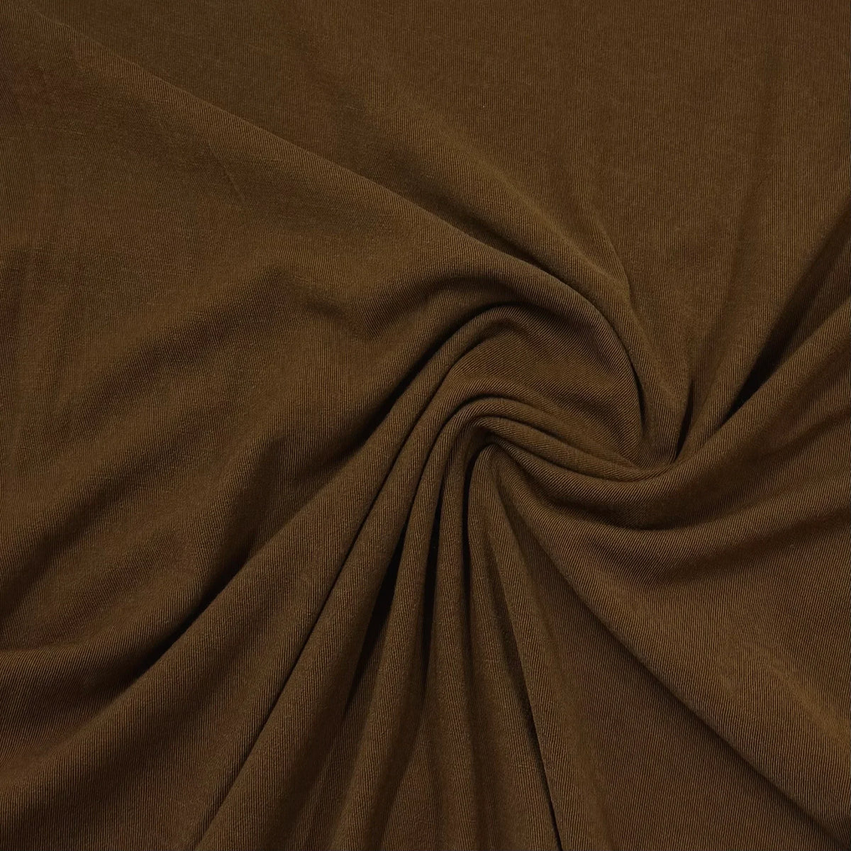 Brown organic cotton fabric draped in a spiral by Nature's Fabrics
