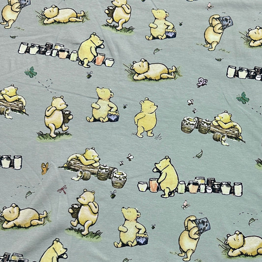 Winnie the Pooh and Honey Pots on Green Organic Cotton/Spandex Jersey Fabric