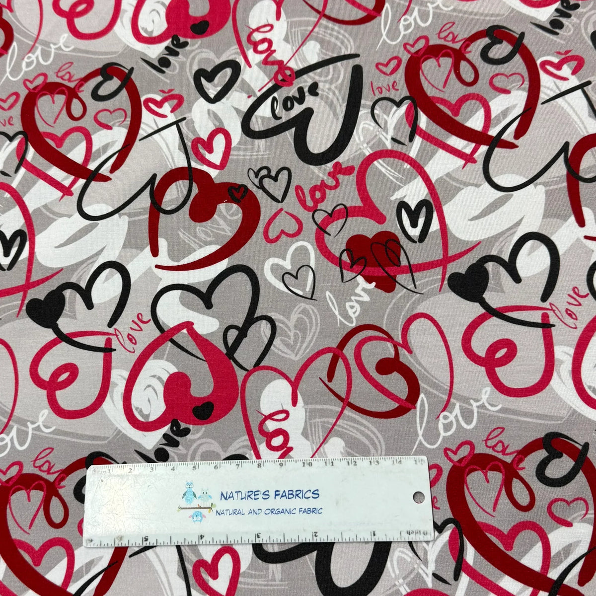 Nature's Fabrics organic cotton fabric with red, black, and white love hearts pattern, eco-friendly by the yard