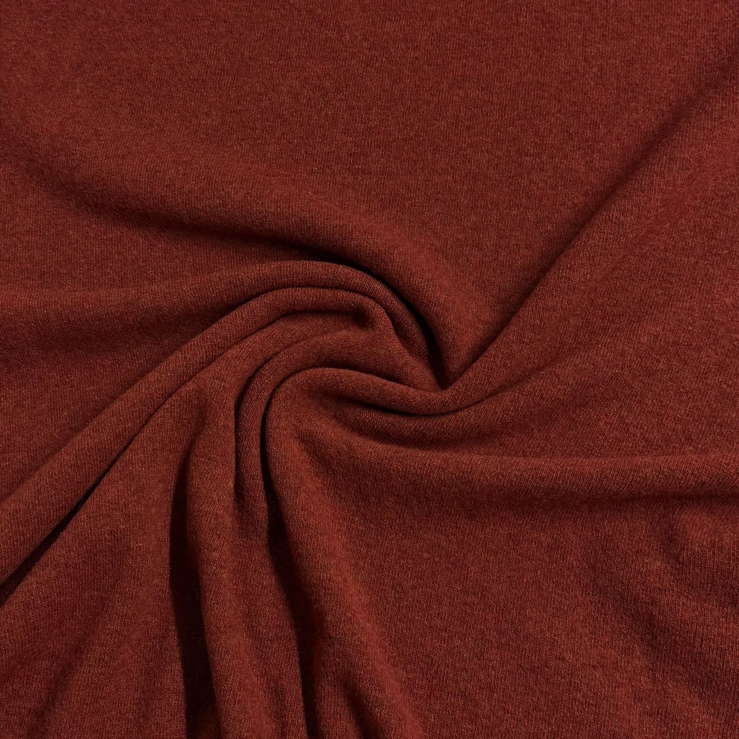 Rich rust-colored organic cotton fabric swirled for texture — Nature's Fabrics