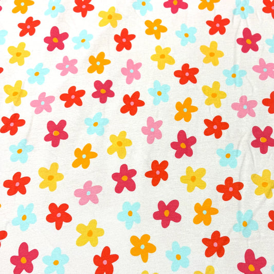 Nature's Fabrics white cotton fabric with colorful multi-colored floral pattern