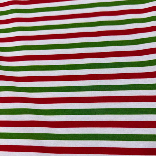 Red, green, and white striped fabric by Nature's Fabrics, ideal for holiday sewing projects and crafts.