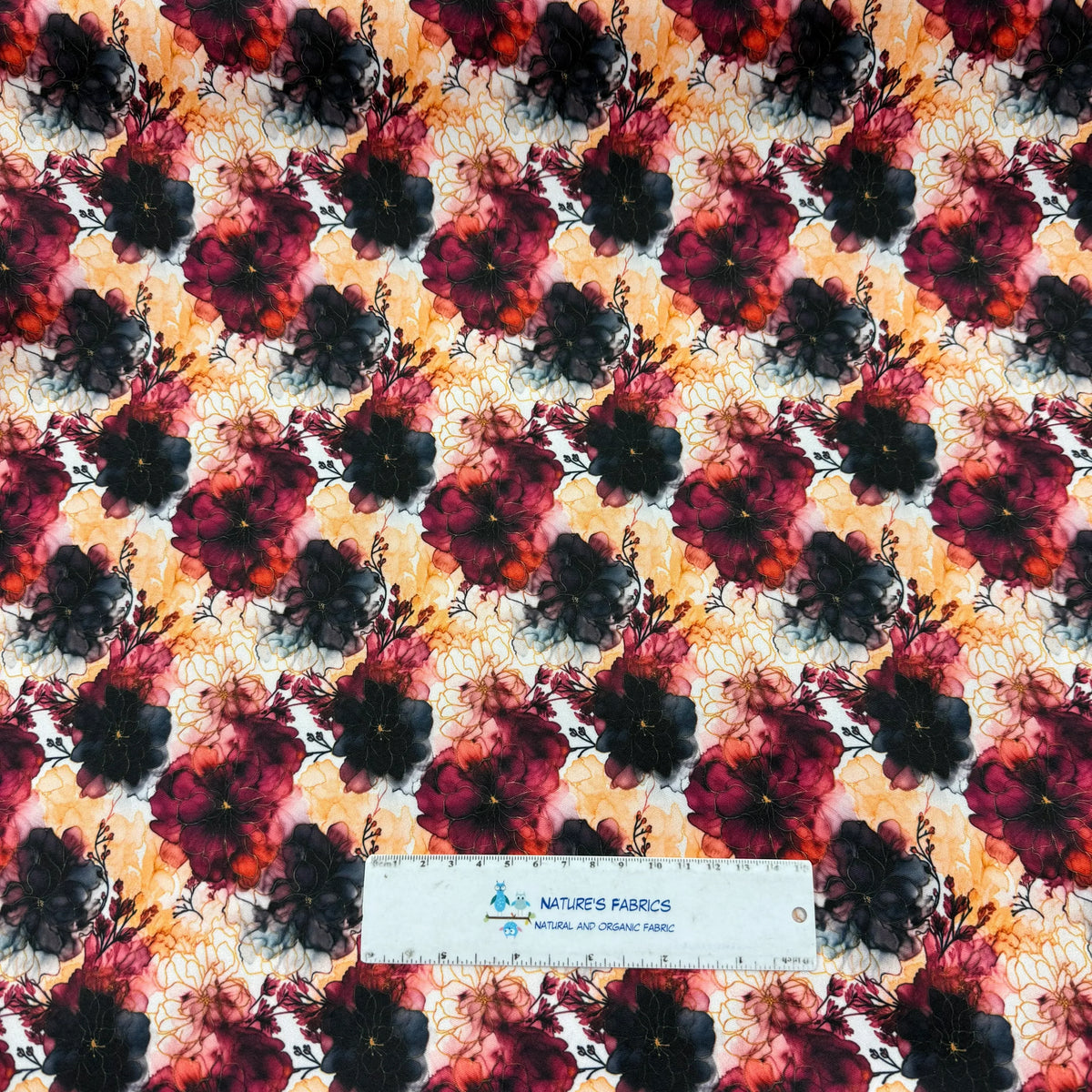 Nature's Fabrics floral print organic cotton fabric with vibrant red and black blooms