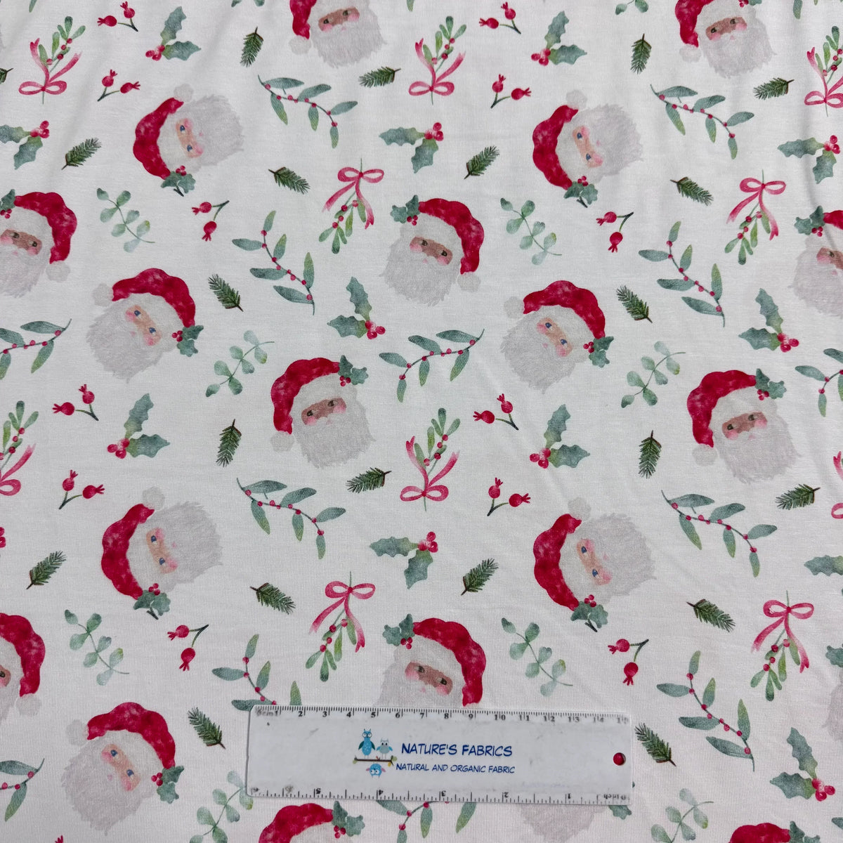 Nature's Fabrics Christmas Santa print organic cotton fabric with holly and bows