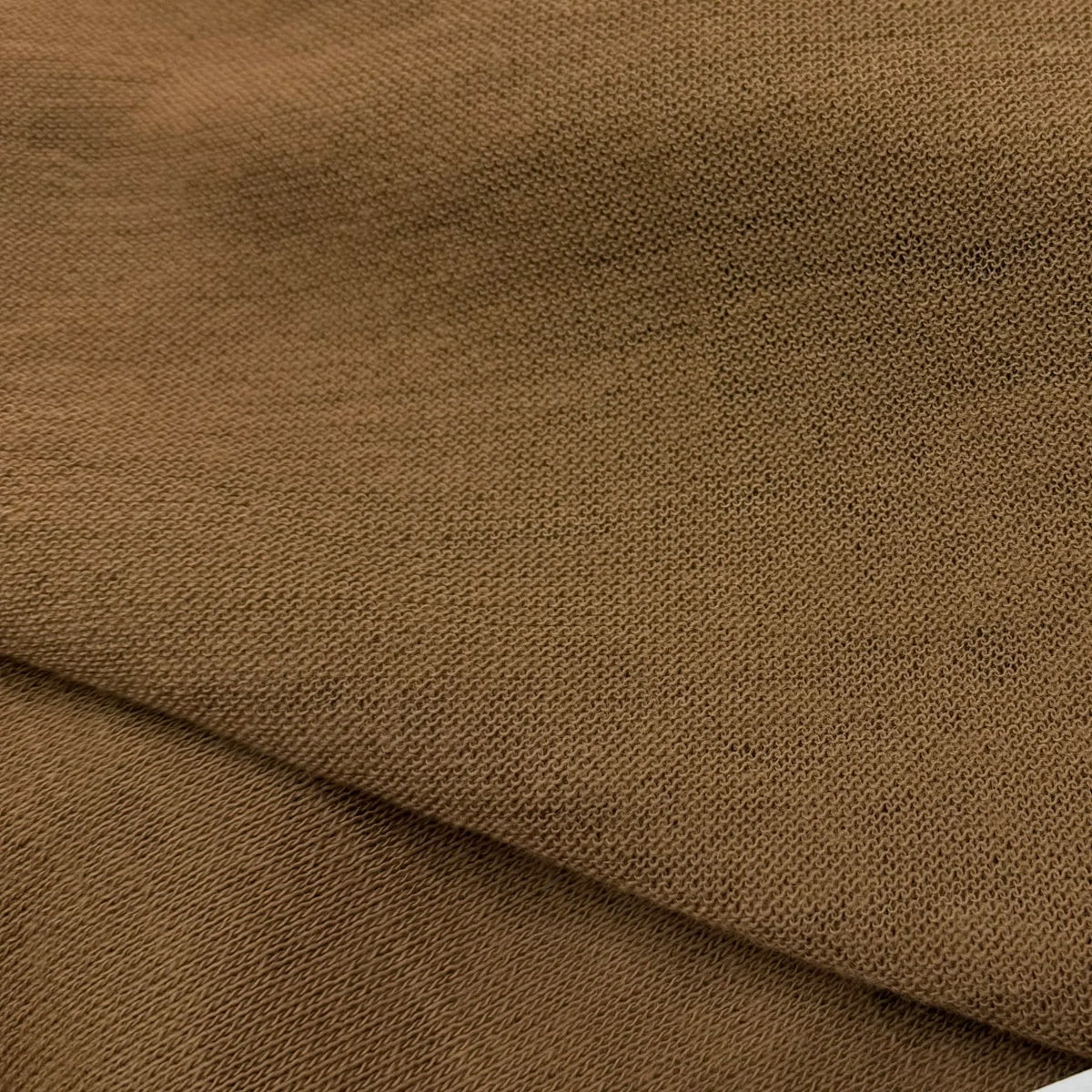 Nature's Fabrics organic cotton knit fabric in warm brown, soft texture for eco-friendly sewing projects
