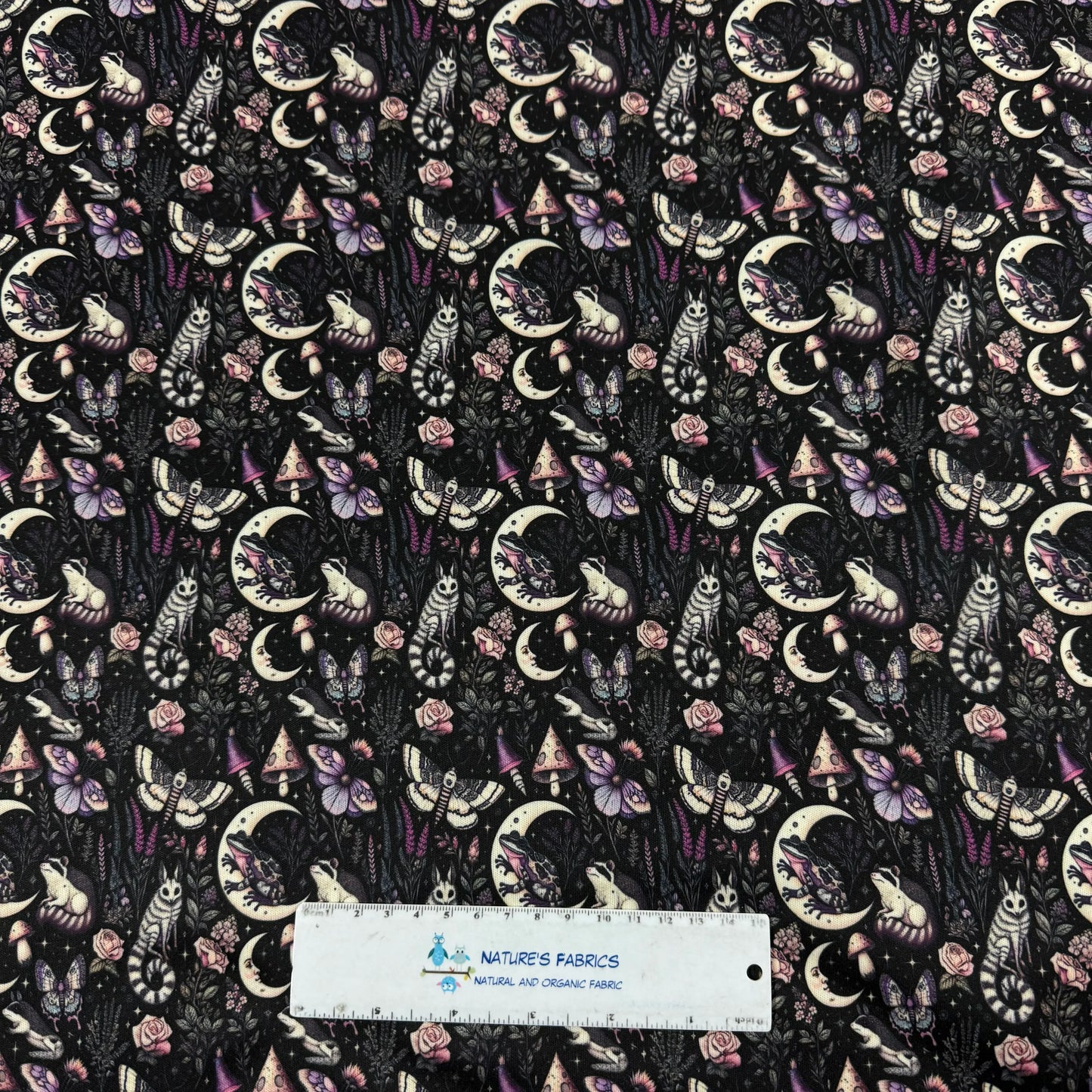 Nature's Fabrics: mystical moon, frogs, owls, mushrooms, and roses on dark fabric, organic cotton print