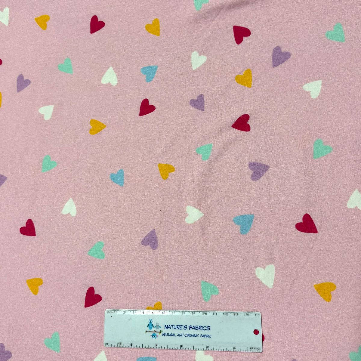 Pink fabric with colorful hearts by Nature's Fabrics, natural organic cotton yardage
