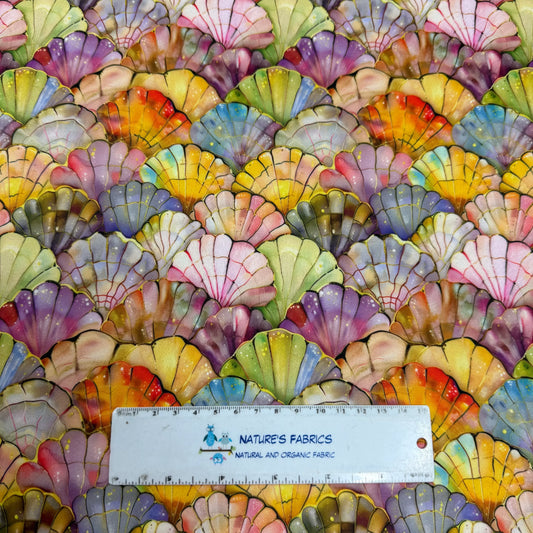 Nature's Fabrics multi-colored seashell print fabric with a ruler for scale