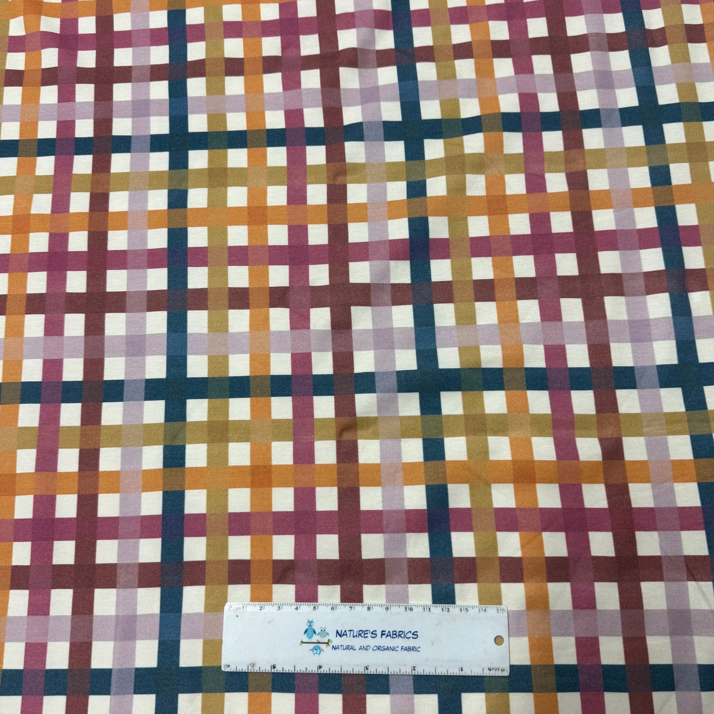 Nature's Fabrics plaid pattern organic cotton fabric with ruler for scale, eco-friendly textile